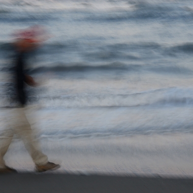 motion blur, man walking on beach, waves, last light of day